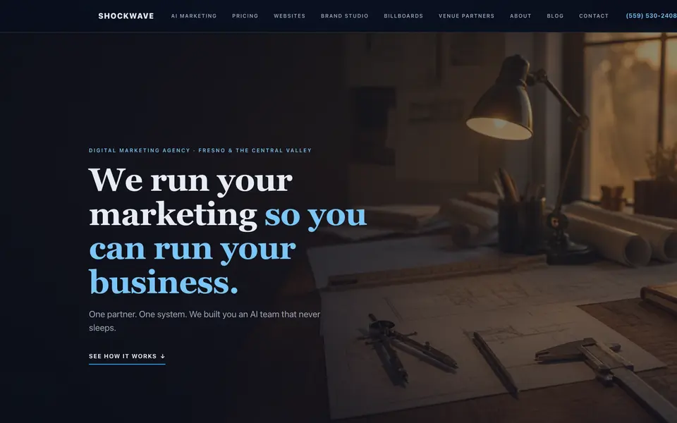 The home page of shockwave-advertising.com: the headline 'We run your marketing so you can run your business.' over a dim photo of a drafting desk.